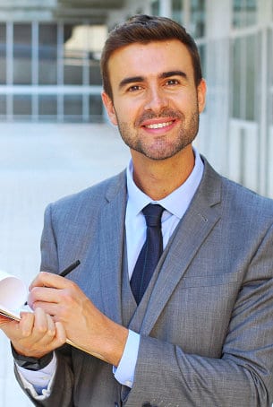 Portrait of man smiling and while writing